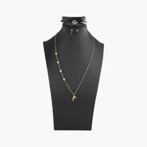 Black jewelry display stand showcasing gold necklace with pearls and earrings for retail or personal collection.