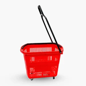 Side view of a red rolling shopping basket with four swivel wheels and a long black telescoping handle raised for pulling while walking.